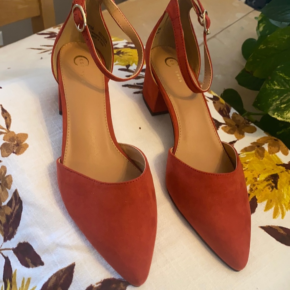 Burnt orange suede with pointed toes, ankle straps and chunky 1 3/4 inch heel.